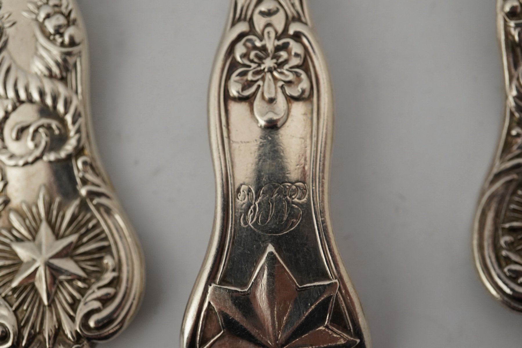 A part canteen of early Victorian silver flatware, by Robert Wallis, double struck with an unusual pattern with entwined cornucopia and a raised star terminal